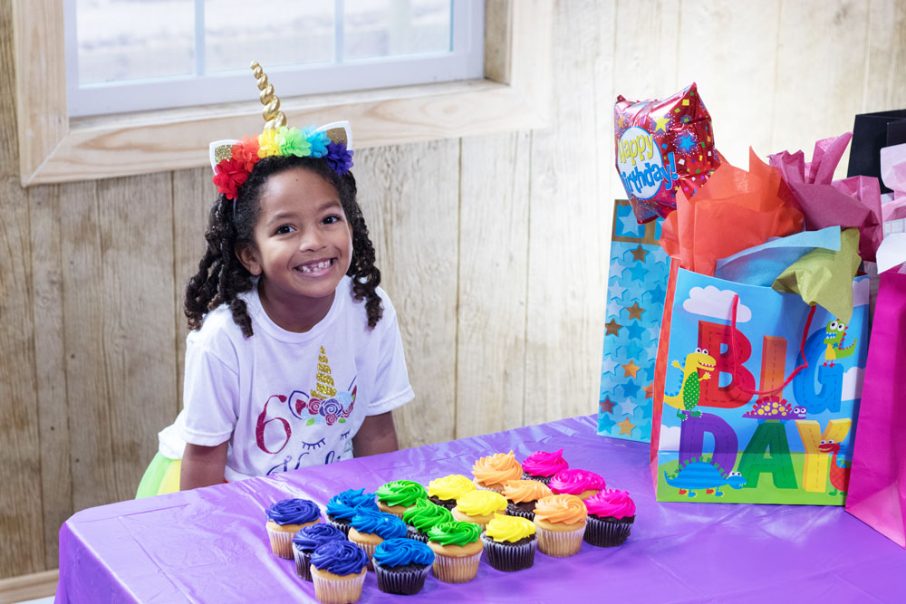 Young Girl With Cupcakes At Birthday Party